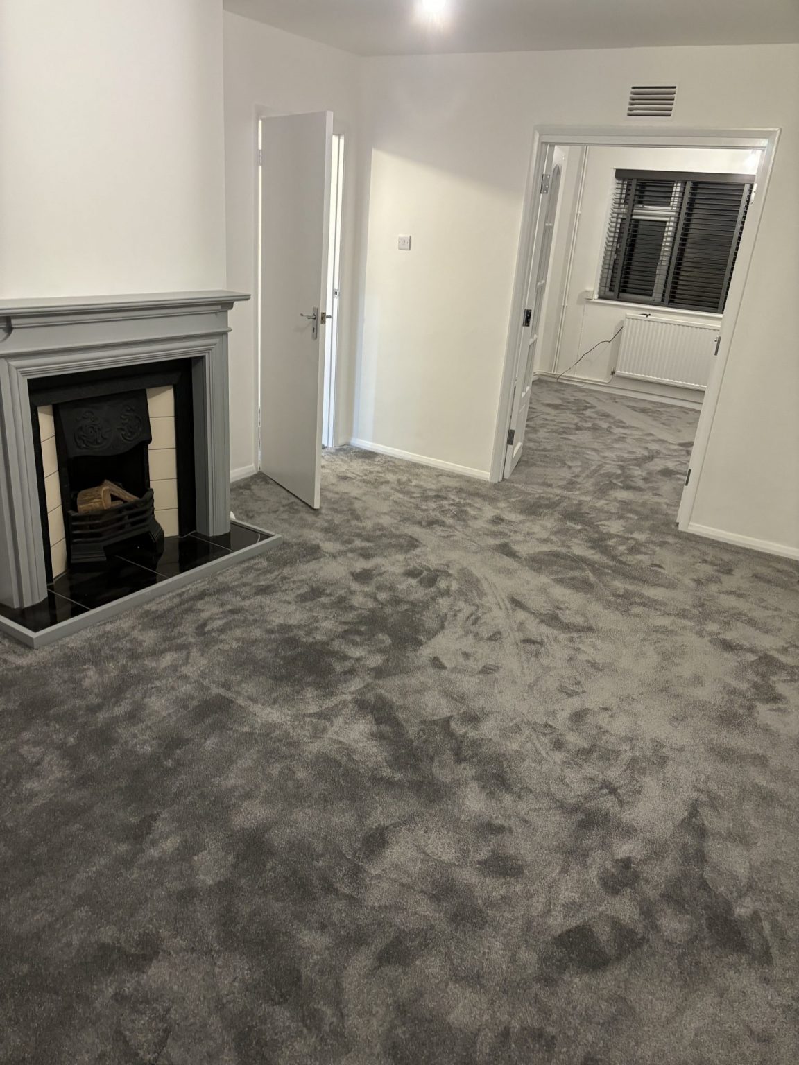 A living room finished with fresh, deep-pile carpet wall to wall